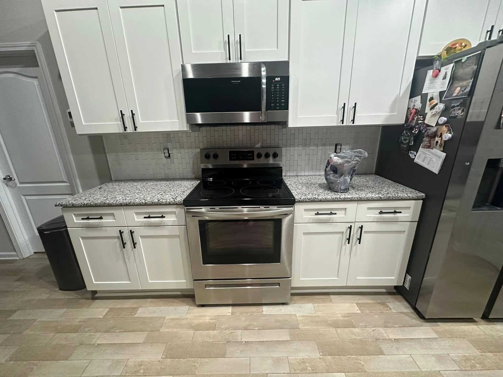 Finished kitchen with new tile backsplash, cabinets and appliances